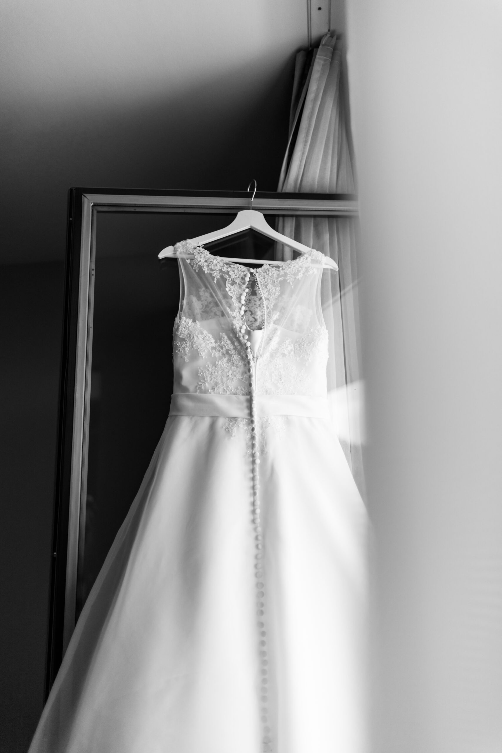 Brautkleid hängt am Fenster.