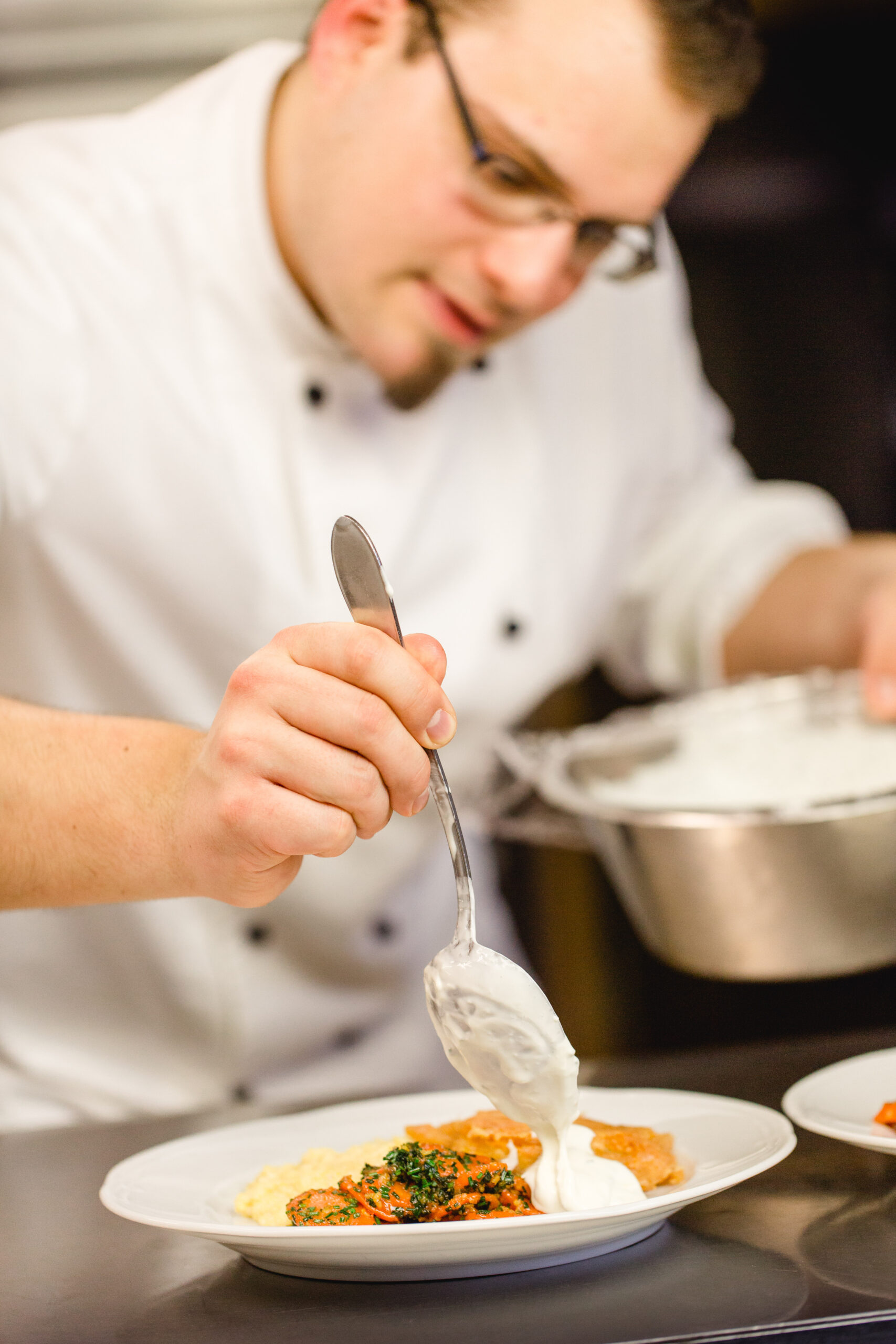 Koch bei der Zubereitung – Küche Schloss St. Martin